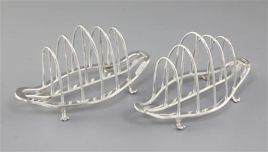 A matched pair of George V silver toast racks, by George Howson, Length 153mm weight 7.7oz/241grms